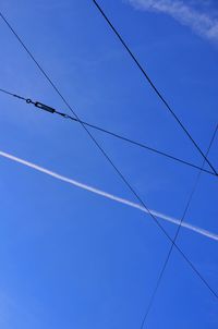 Low angle view of cables against blue sky
