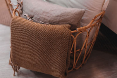 Beige fabrics in a wicker basket. cozy details in the home interior. autumn colors