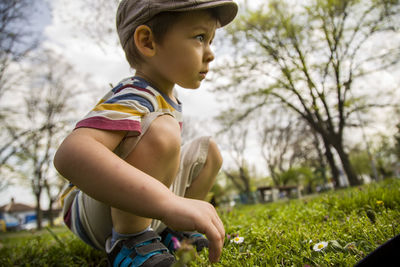 Side view of boy looking at camera