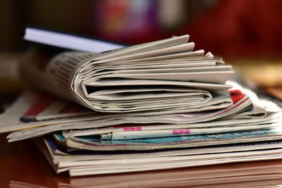 Close-up of newspapers on table