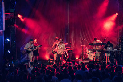 People enjoying music concert at night