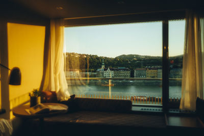 Glass table by window against clear sky