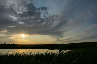 Scenic view of field against sky during sunset