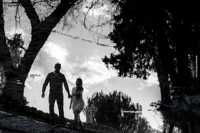 Reflection of people in lake