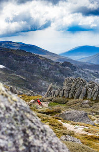 Person riding mountain bike against sky