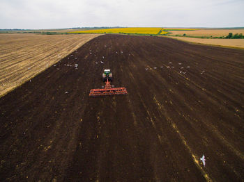 High angle view of agricultural machinery working at farm