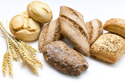 Delicious breads next to the spikes on a white background.