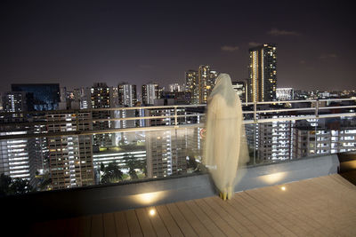 Illuminated buildings against sky at night