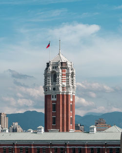 Low angle view of buildings against cloudy sky