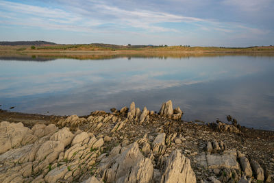 Lucefecit dam in terena with reflection on the lake reservoir and rocks, in portugal