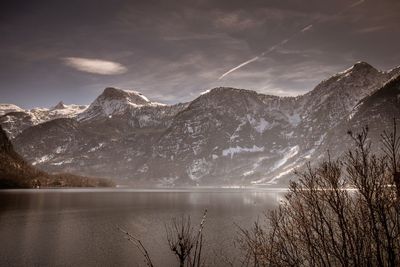 Scenic view of lake and mountains against sky during winter