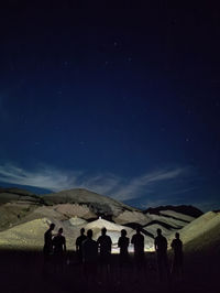 Silhouettes of men at firing range