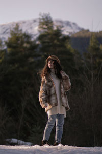 Full length of woman standing in snow