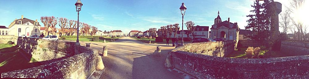 Panoramic view of buildings in town against sky