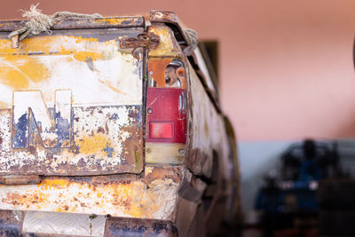 Detail of the front headlight of an old car in garage