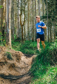 Full length of man running in forest