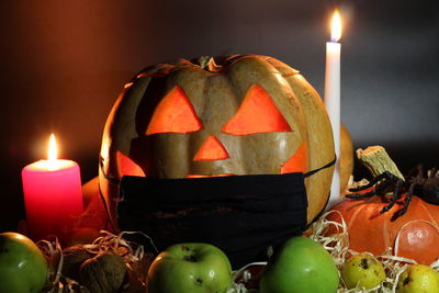 Close-up of illuminated pumpkin against black background