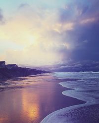 Scenic view of beach against sky during sunset