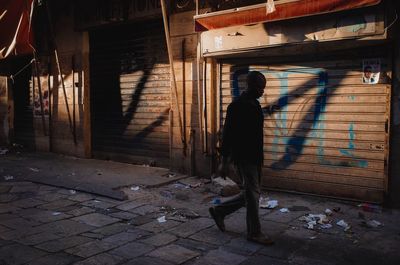 Woman standing on cobblestone street