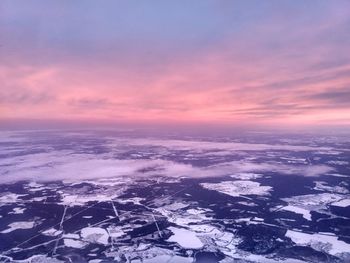 Aerial view of sea against sky during sunset