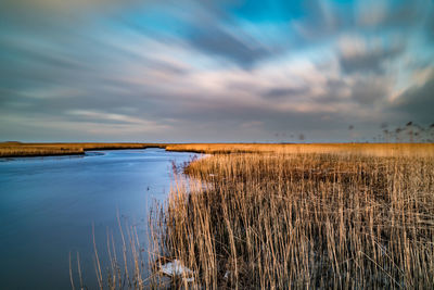 Scenic view of lake against sky during sunset