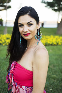 Beautiful brunette woman with blue eyes in the park