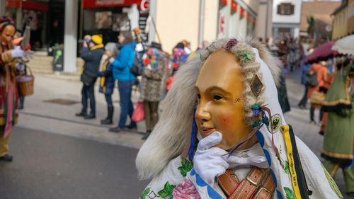 Portrait of young woman looking at city street