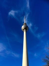 Low angle view of fernsehturm against blue sky