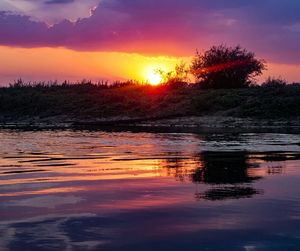 Scenic view of lake against romantic sky at sunset