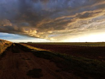 Scenic view of field against sky during sunset