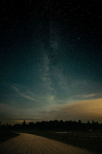 Scenic view of landscape against sky at night