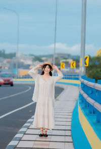 Rear view of woman standing in boat