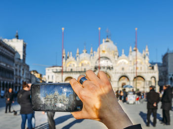 Man photographing with city in background - venice, italy