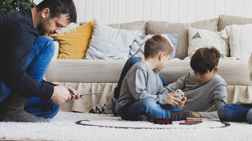 Rear view of people sitting on sofa