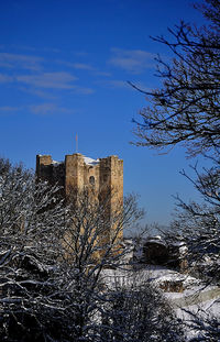 Low angle view of building against sky during winter