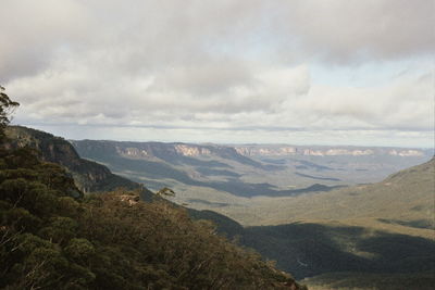 Scenic view of mountains against cloudy sky