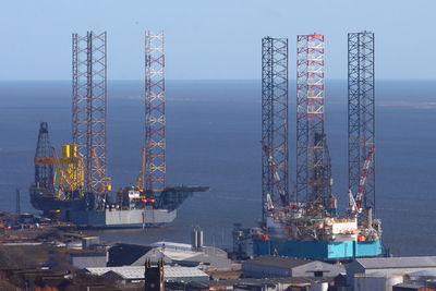 Commercial dock by sea against sky