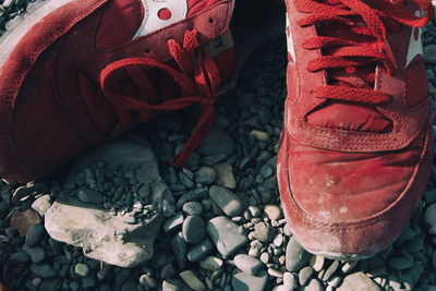 High angle view of abandoned red shoes