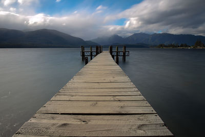 Pier over lake against sky