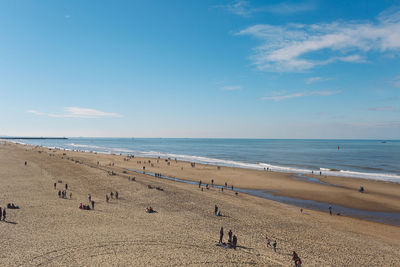 Scenic view of beach and sea against blue sky 