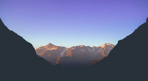 Scenic view of mountains against clear blue sky