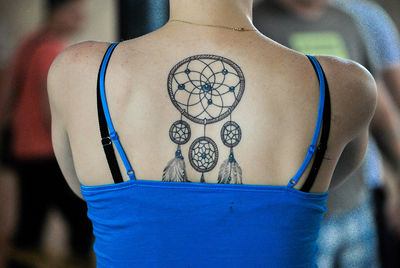 Rear view of woman with dreamcatcher on back