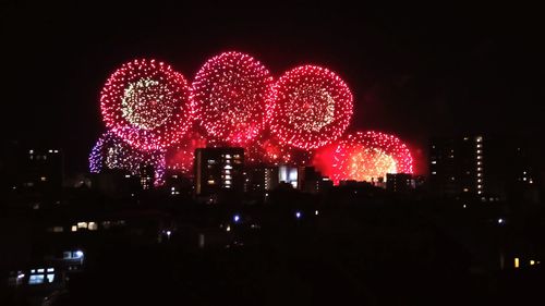 Firework display in city at night