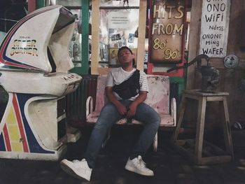 Portrait of young man sitting on chair