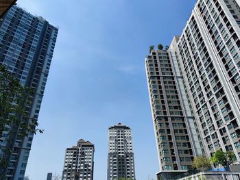 Low angle view of buildings against sky in city