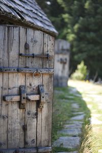 Close-up of wooden hut in field