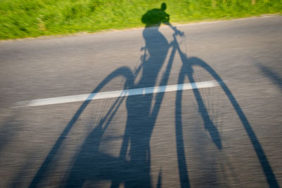 High angle view of people shadow on road