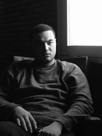 Portrait of young man sitting at home