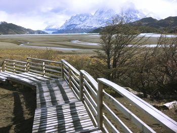 Scenic view of lake by mountains against sky