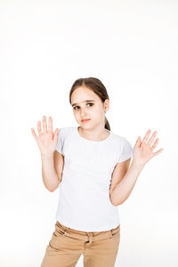 Portrait of young woman standing against white background